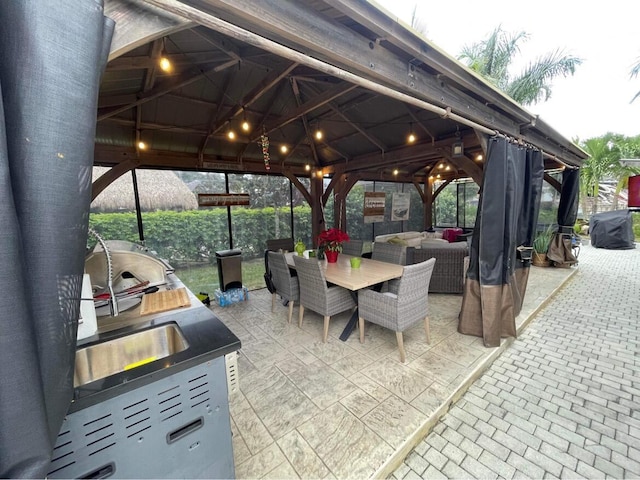 view of patio featuring a gazebo, outdoor dining space, and an outdoor hangout area