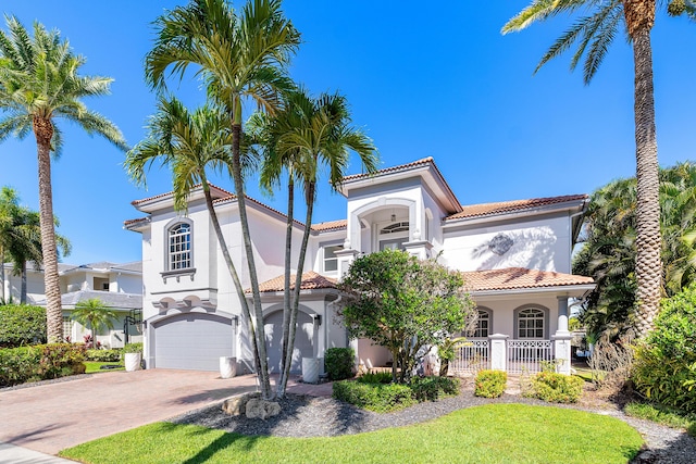 16313 Mira Vista Ln, Delray Beach, FL 33446 - mediterranean / spanish house featuring stucco siding, a tile roof, decorative driveway, a garage, and a porch