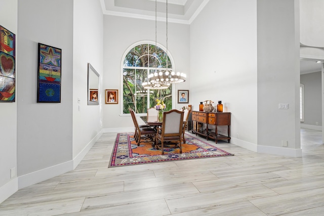 16313 Mira Vista Ln, Delray Beach, FL 33446 - dining area featuring a high ceiling, crown molding, baseboards, a chandelier, and wood finished floors