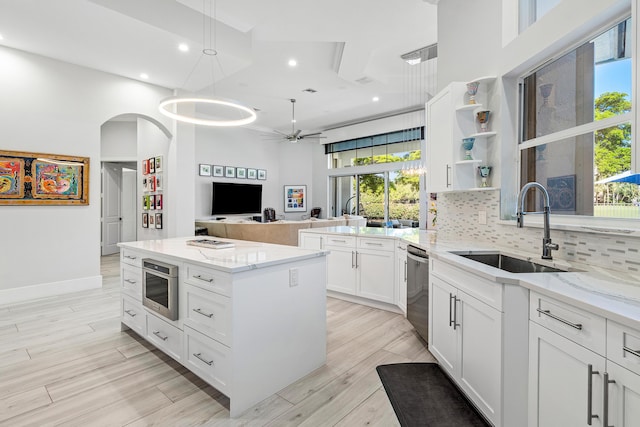16313 Mira Vista Ln, Delray Beach, FL 33446 - kitchen featuring a sink, stainless steel dishwasher, healthy amount of natural light, recessed lighting, and a towering ceiling