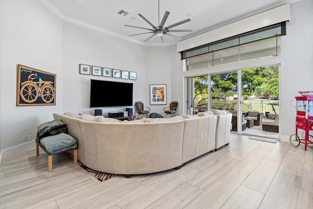16313 Mira Vista Ln, Delray Beach, FL 33446 - living room featuring a high ceiling, ornamental molding, a ceiling fan, baseboards, and light wood-style floors