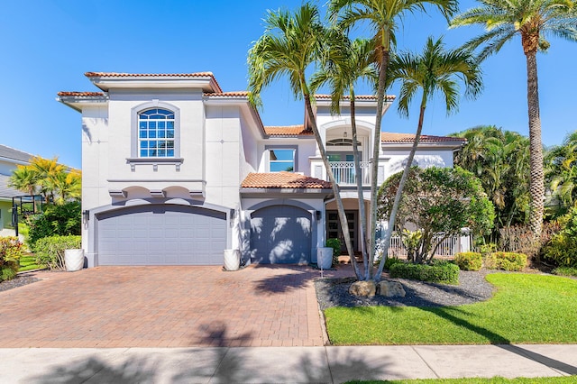 16313 Mira Vista Ln, Delray Beach, FL 33446 - mediterranean / spanish house featuring a tiled roof, decorative driveway, a garage, a balcony, and stucco siding