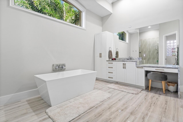 16313 Mira Vista Ln, Delray Beach, FL 33446 - bathroom with vanity, a stall shower, wood finished floors, and a freestanding tub