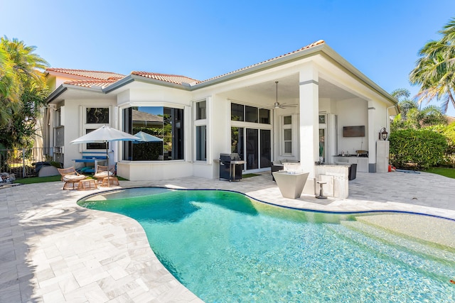 16313 Mira Vista Ln, Delray Beach, FL 33446 - view of swimming pool featuring a patio, a ceiling fan, and exterior kitchen
