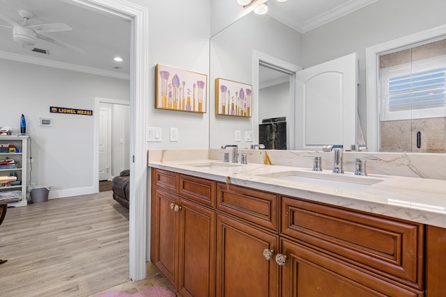 16313 Mira Vista Ln, Delray Beach, FL 33446 - full bath with ornamental molding, wood finished floors, double vanity, ceiling fan, and baseboards