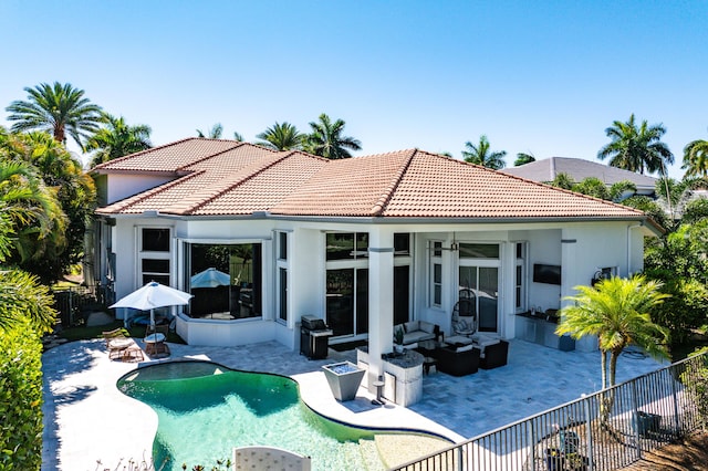 16313 Mira Vista Ln, Delray Beach, FL 33446 - rear view of property featuring an outdoor hangout area, a patio, a tile roof, and stucco siding