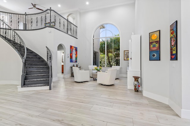 16313 Mira Vista Ln, Delray Beach, FL 33446 - entrance foyer featuring a towering ceiling, arched walkways, stairway, baseboards, and recessed lighting