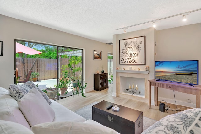 1518 15th Ln, Palm Beach Gardens, FL 33418 - living area with track lighting, wood finished floors, and a textured ceiling