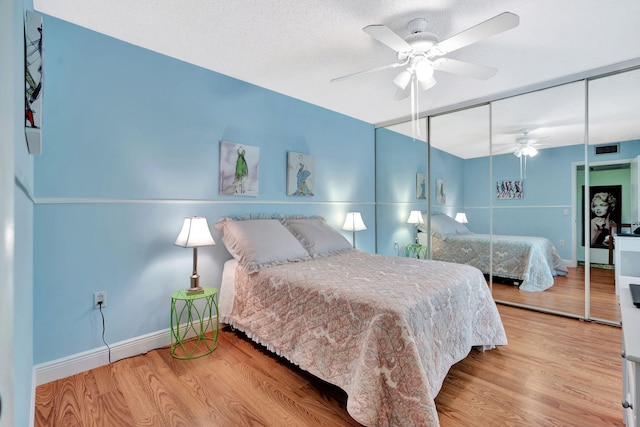 1518 15th Ln, Palm Beach Gardens, FL 33418 - bedroom with wood finished floors, a closet, and a ceiling fan