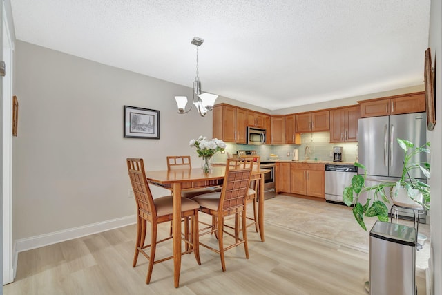 1518 15th Ln, Palm Beach Gardens, FL 33418 - dining room with a chandelier and light wood-type flooring
