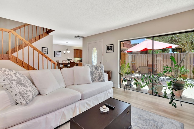 1518 15th Ln, Palm Beach Gardens, FL 33418 - living area with wood finished floors, stairway, plenty of natural light, and a textured ceiling