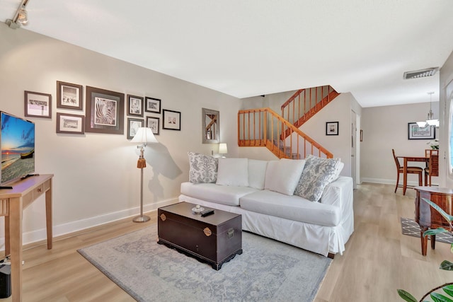 1518 15th Ln, Palm Beach Gardens, FL 33418 - living room with light wood-style flooring, stairway, and a chandelier