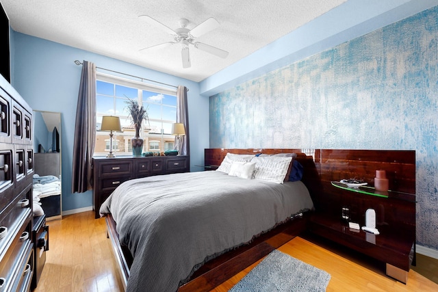 1801 N Flagler Dr Unit 931, West Palm Beach, FL 33407 - bedroom with light wood-type flooring, a textured ceiling, ceiling fan, and baseboards