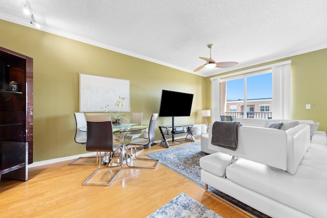 1801 N Flagler Dr Unit 931, West Palm Beach, FL 33407 - living room featuring a textured ceiling, crown molding, wood finished floors, a ceiling fan, and baseboards