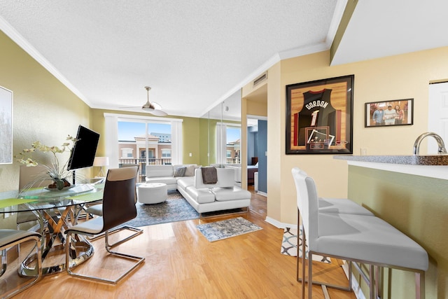 1801 N Flagler Dr Unit 931, West Palm Beach, FL 33407 - living area with ornamental molding, wood finished floors, ceiling fan, baseboards, and a textured ceiling