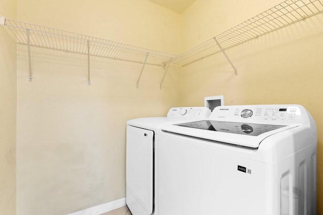 1801 N Flagler Dr Unit 931, West Palm Beach, FL 33407 - washroom featuring washing machine and clothes dryer and baseboards