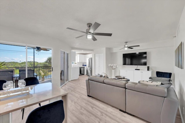 275 Palm Ave Unit B304, Jupiter, FL 33477 - living room featuring light wood-style flooring and ceiling fan