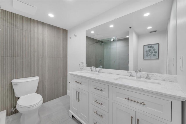 275 Palm Ave Unit B304, Jupiter, FL 33477 - full bathroom with double vanity, recessed lighting, toilet, a stall shower, and tile walls