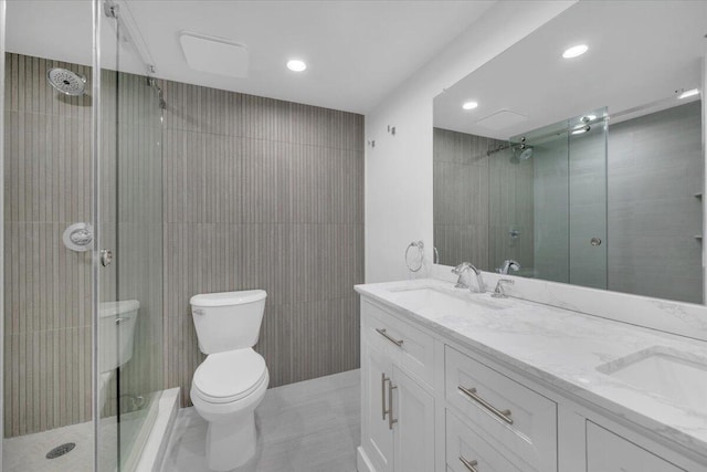 275 Palm Ave Unit B304, Jupiter, FL 33477 - full bathroom featuring toilet, a shower stall, double vanity, recessed lighting, and tile patterned flooring