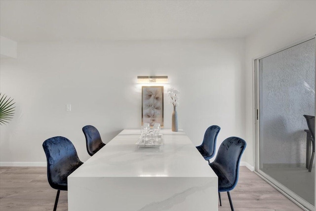 275 Palm Ave Unit B304, Jupiter, FL 33477 - dining space with light wood-style flooring and baseboards