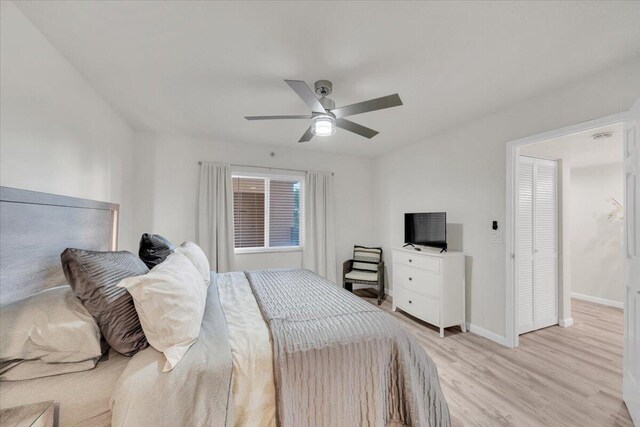 275 Palm Ave Unit B304, Jupiter, FL 33477 - bedroom with light wood-type flooring, baseboards, and a ceiling fan