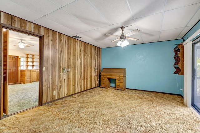 13705 Persimmon Blvd, The Acreage, FL 33411 - unfurnished living room with wooden walls, carpet, a drop ceiling, ceiling fan, and healthy amount of natural light