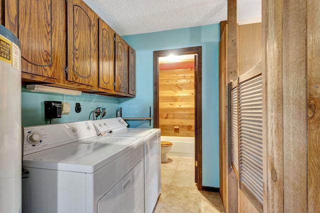 13705 Persimmon Blvd, The Acreage, FL 33411 - laundry area featuring washing machine and dryer, a textured ceiling, and cabinet space