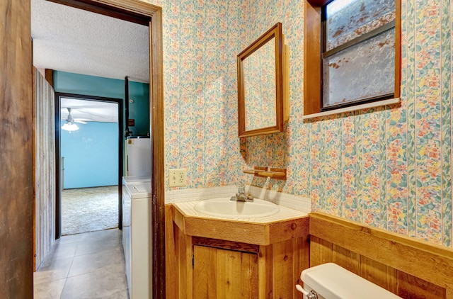 13705 Persimmon Blvd, The Acreage, FL 33411 - bathroom with wallpapered walls, washer / clothes dryer, vanity, toilet, and gas water heater