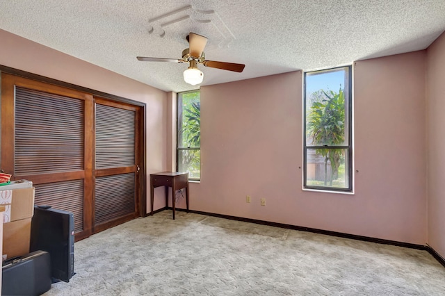 13705 Persimmon Blvd, The Acreage, FL 33411 - spare room featuring carpet flooring, a ceiling fan, baseboards, and a textured ceiling
