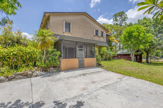 13705 Persimmon Blvd, The Acreage, FL 33411 - back of property featuring a sunroom, stucco siding, and a yard