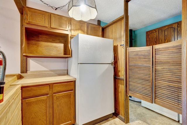 13705 Persimmon Blvd, The Acreage, FL 33411 - kitchen with freestanding refrigerator, light countertops, open shelves, and brown cabinetry