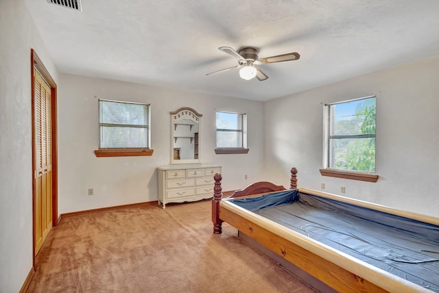 13705 Persimmon Blvd, The Acreage, FL 33411 - bedroom with multiple windows, light carpet, a closet, and baseboards