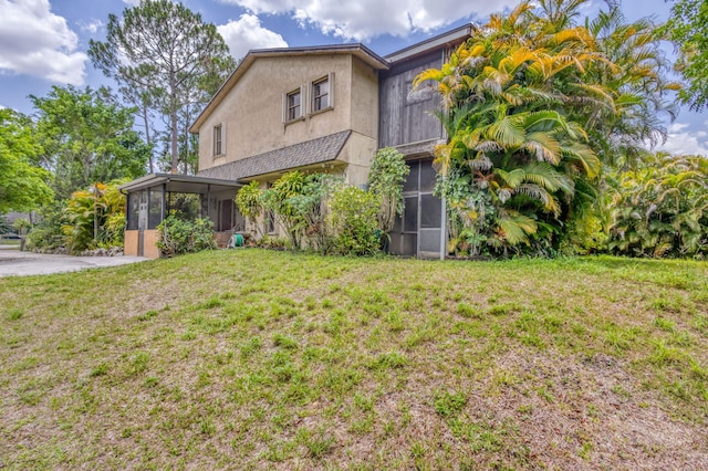 13705 Persimmon Blvd, The Acreage, FL 33411 - view of front of property with a sunroom, a front yard, and stucco siding