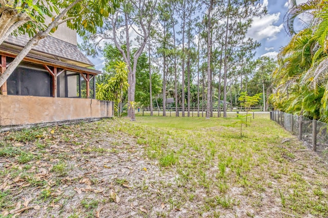 13705 Persimmon Blvd, The Acreage, FL 33411 - view of yard featuring fence and a sunroom