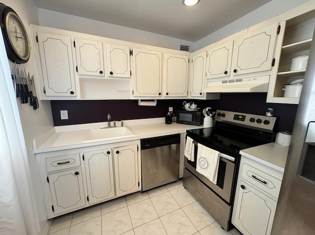 521 Saxony K, Delray Beach, FL 33446 - kitchen with under cabinet range hood, appliances with stainless steel finishes, a sink, light countertops, and open shelves