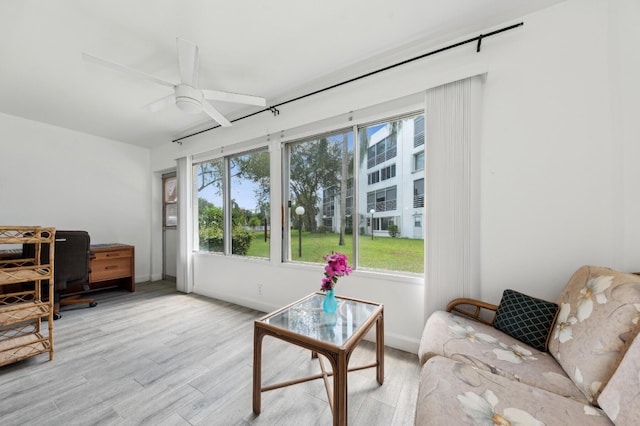 3186 Via Poinciana Unit 115, Lake Worth, FL 33467 - living room featuring wood finished floors, a desk, ceiling fan, and baseboards