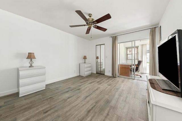 3186 Via Poinciana Unit 115, Lake Worth, FL 33467 - unfurnished bedroom featuring baseboards, light wood-type flooring, and a ceiling fan