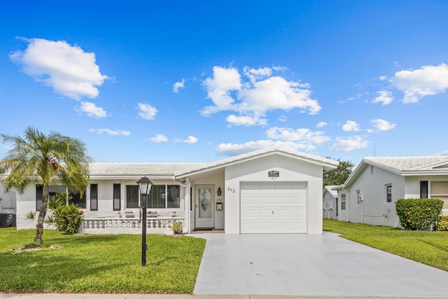 ranch-style house featuring concrete driveway, an attached garage, a front yard, and stucco siding