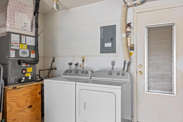 washroom featuring washer and dryer, electric panel, and heating unit