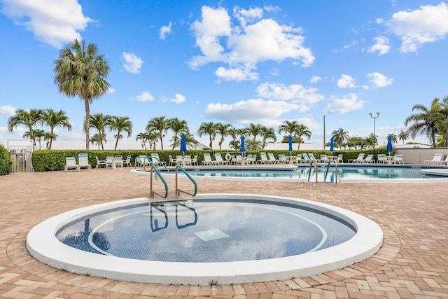 community pool featuring a patio and fence
