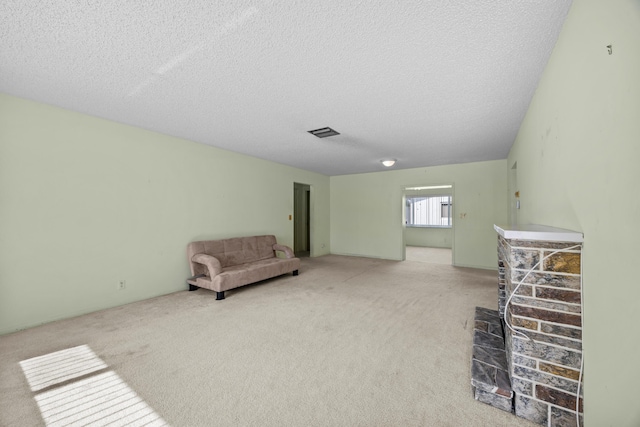 unfurnished room featuring a textured ceiling and carpet