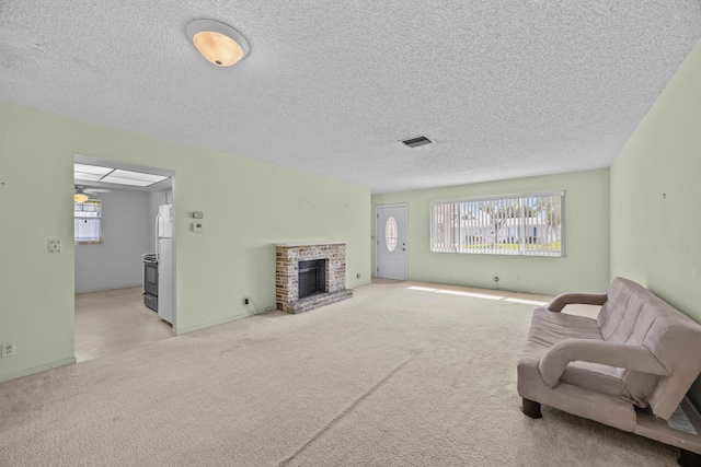 carpeted living room with a fireplace, a textured ceiling, and a ceiling fan