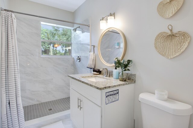 2559 Conroy Dr, North Palm Beach, FL 33403 - bathroom with tiled shower, vanity, and toilet