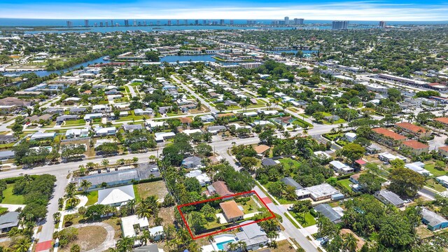 2559 Conroy Dr, North Palm Beach, FL 33403 - aerial view of property's location featuring property boundaries highlighted, nearby urban area, a large body of water, and nearby suburban area