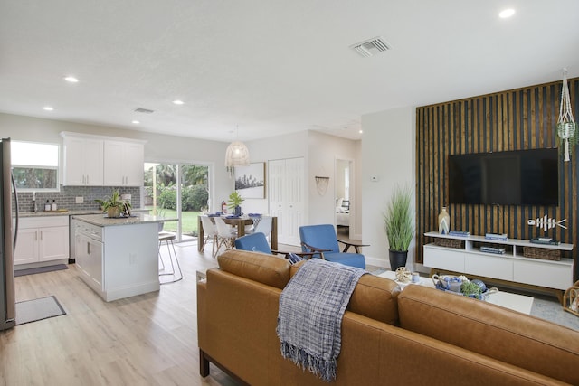 2559 Conroy Dr, North Palm Beach, FL 33403 - living room with healthy amount of natural light, light wood-type flooring, and recessed lighting
