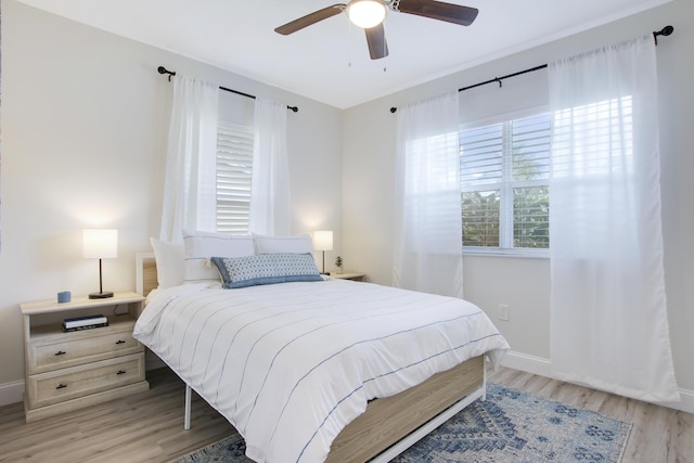 2559 Conroy Dr, North Palm Beach, FL 33403 - bedroom with light wood-type flooring, baseboards, and a ceiling fan