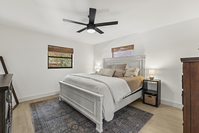 4972 S Kay St, Palm Beach Gardens, FL 33418 - bedroom with light wood-style floors, a ceiling fan, and baseboards