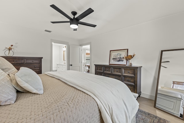 4972 S Kay St, Palm Beach Gardens, FL 33418 - bedroom featuring light wood-style floors, ensuite bathroom, a ceiling fan, and baseboards