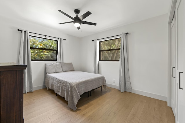 4972 S Kay St, Palm Beach Gardens, FL 33418 - bedroom with light wood finished floors, baseboards, and a ceiling fan