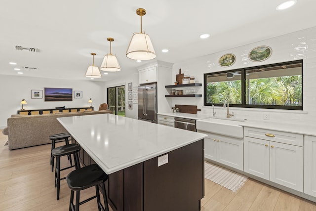 4972 S Kay St, Palm Beach Gardens, FL 33418 - kitchen featuring stainless steel appliances, a sink, recessed lighting, light countertops, and light wood-style flooring